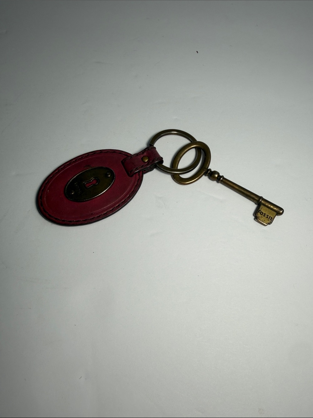 Fossil Red Leather Oval Keychain with Antique Brass Key Charm